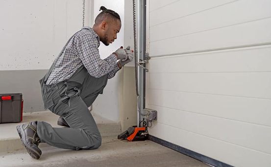 Professional garage door repair technician inspecting a residential garage door in Metro Atlanta